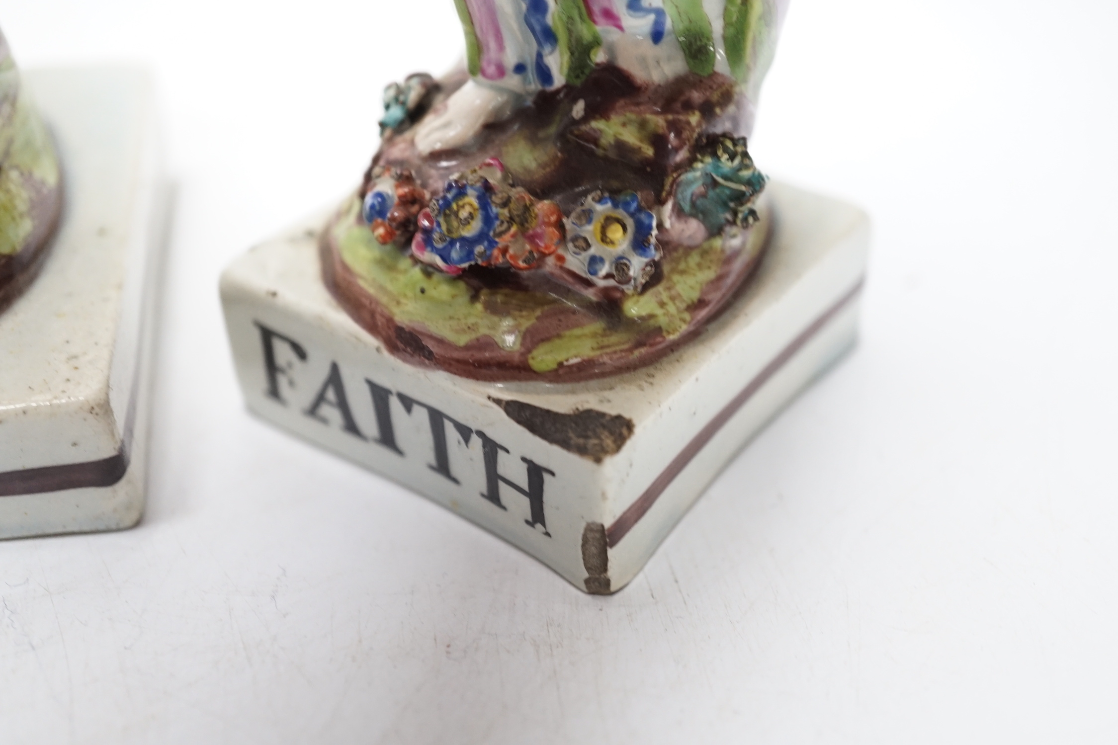 A set of three pearlware figures of Faith, Hope and Charity, c.1810, largest 21cm high